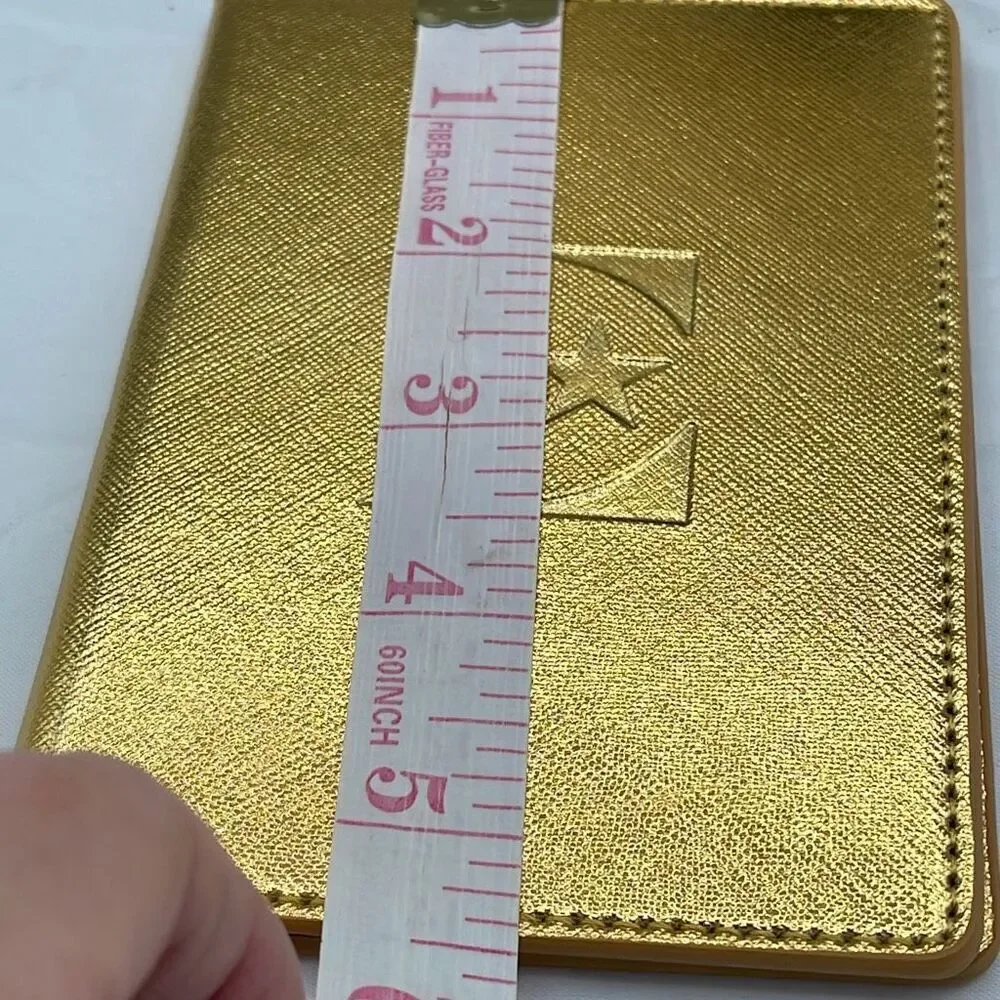 Vintage Elton John gold colored passport cover.